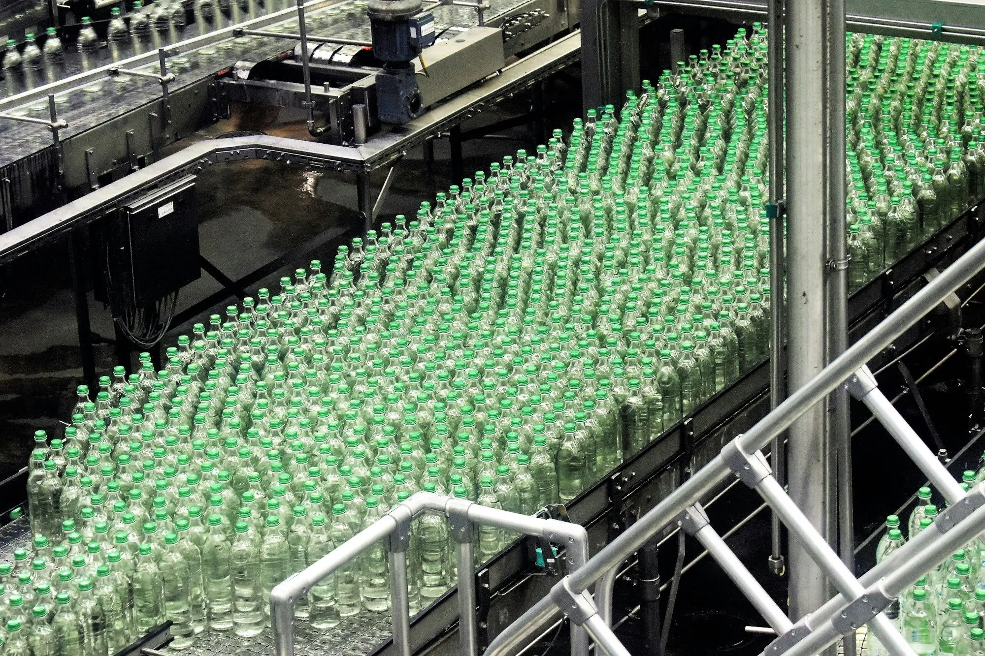 Glass bottles moving along a high-speed filling line