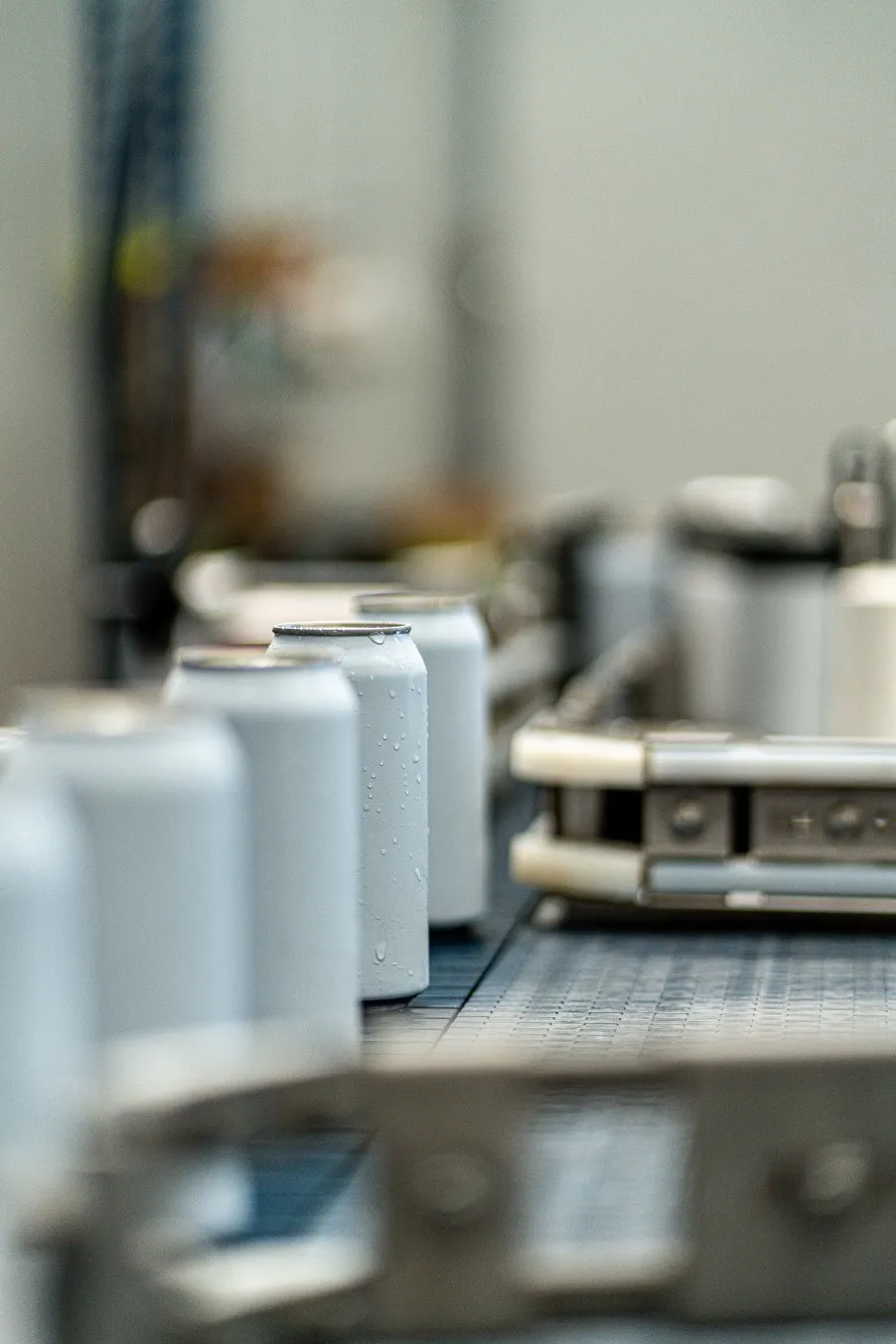 Beverage cans moving along a conveyor on a filling line
