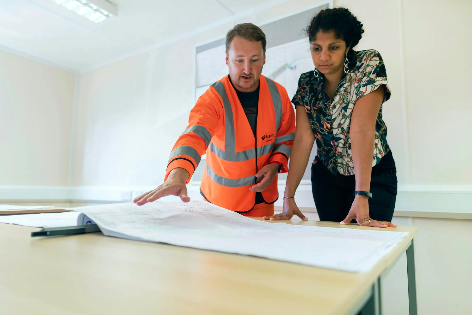 Engineers reviewing project drawings together