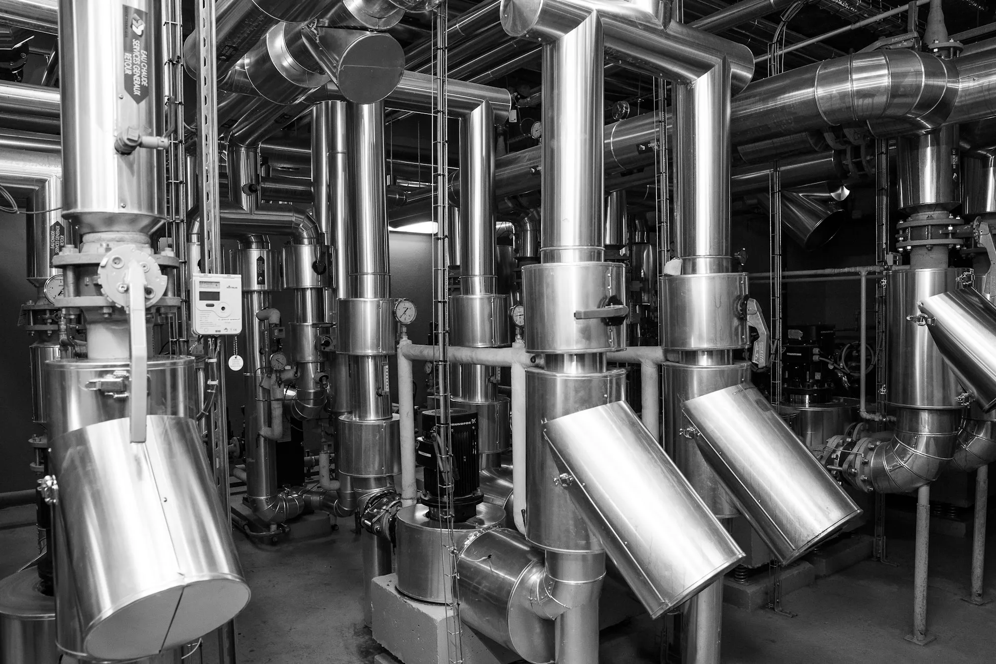 Insulated stainless pipework and valves in a plant room