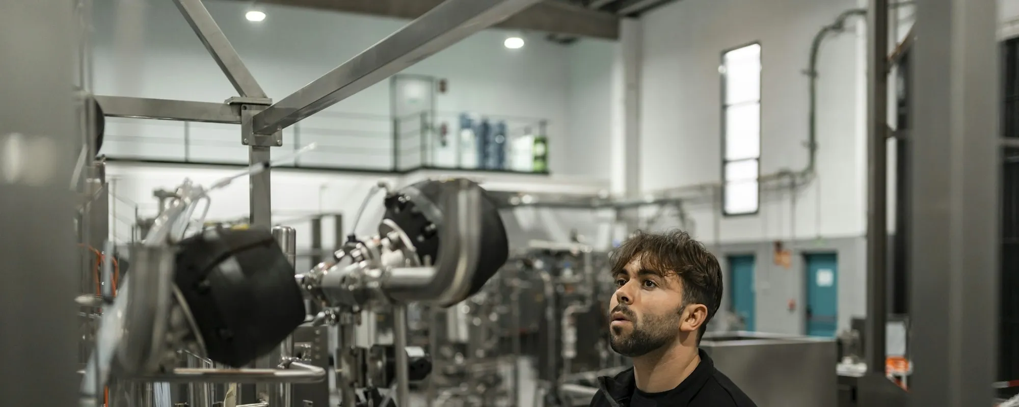 Engineer inspecting process equipment in a validation area